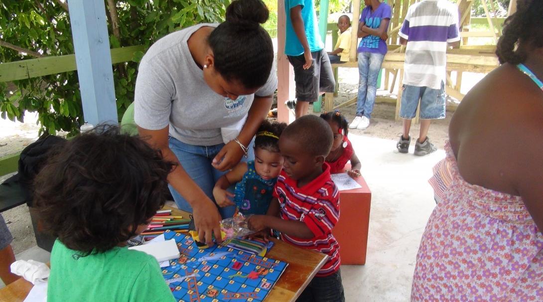A high school student works with children and helps with marine conservation work in Belize A Projects Abroad volunteer does conservation work and teaches children in Belize on our project for teenagers